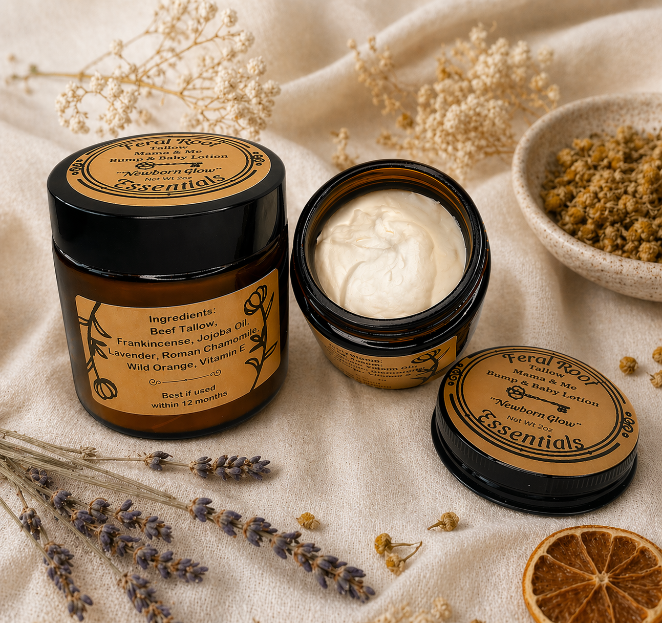 Two jars of Tallow Mama & Me with dried flowers and herbs on a textured fabric background