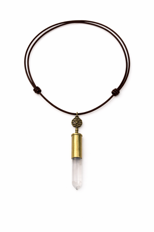 Necklace with a clear crystal pendant and brass accent on a white background